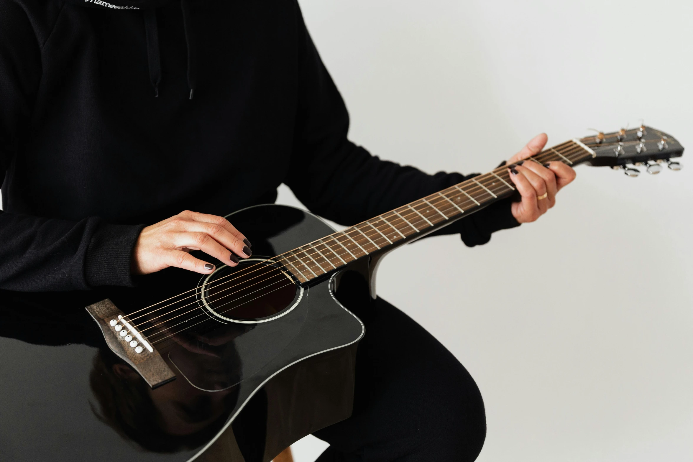 a man is playing an acoustic guitar in front of a white background