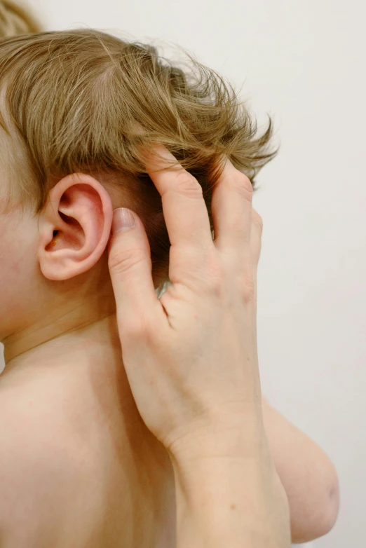 a woman holding her ear to help get ridd