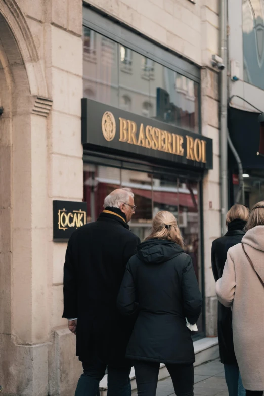 a group of people are walking down the street