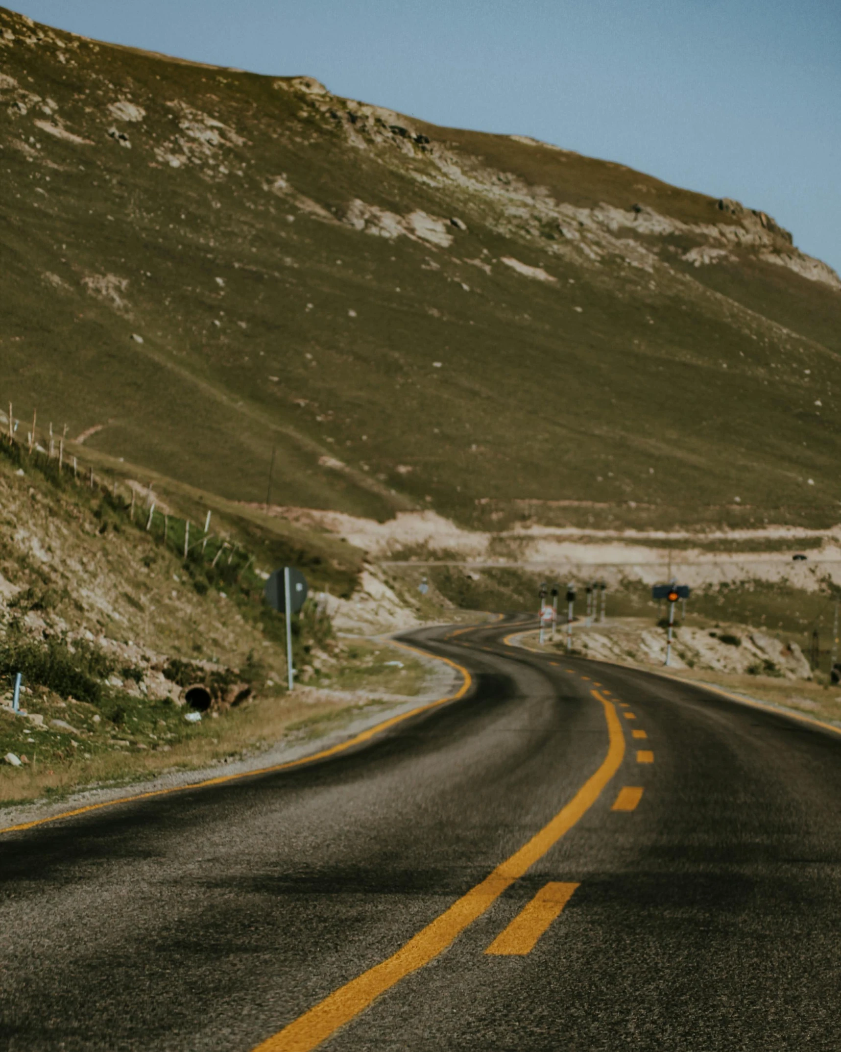 a curve in the road shows how it would look if you were headed down the mountain