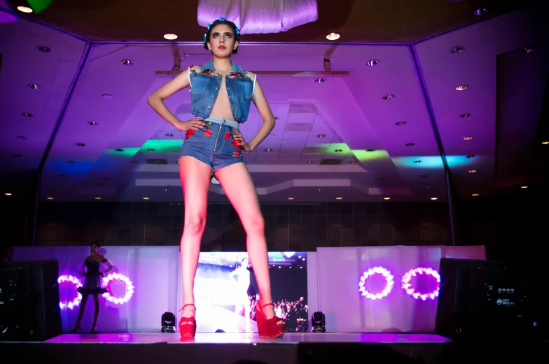 a woman wearing red high heels on top of a runway