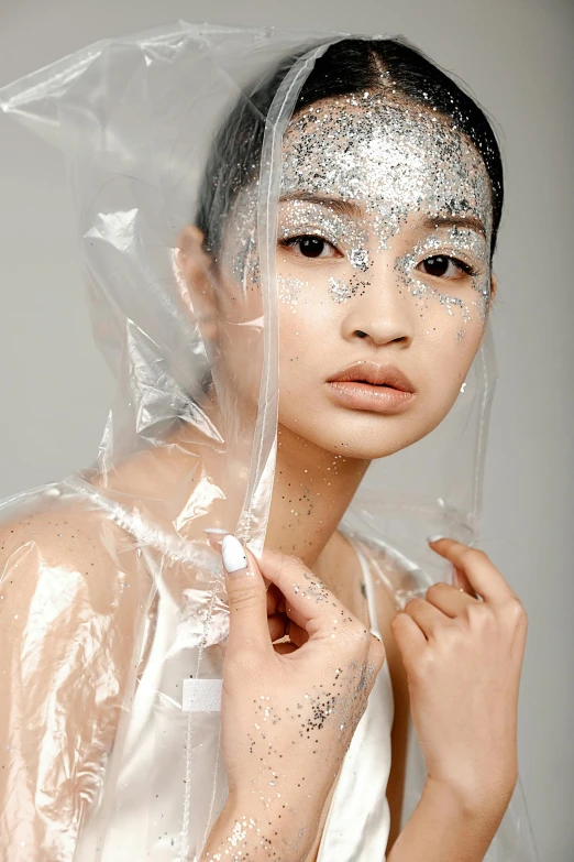 a beautiful young lady with shiny skin wearing a clear plastic bag