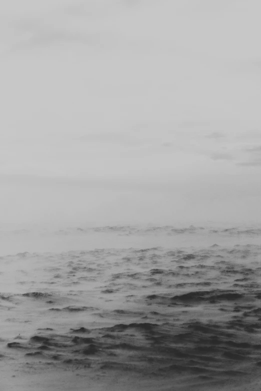 black and white po of sea with distant horizon