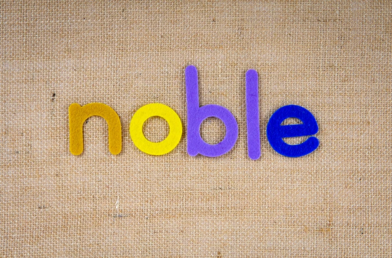 a large, colorful object has the word noble made out of small felt letters
