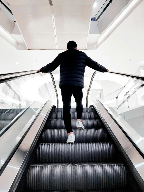 a man on a staircase holding on to the handle bars