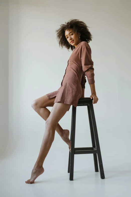 a woman is standing on top of a stool