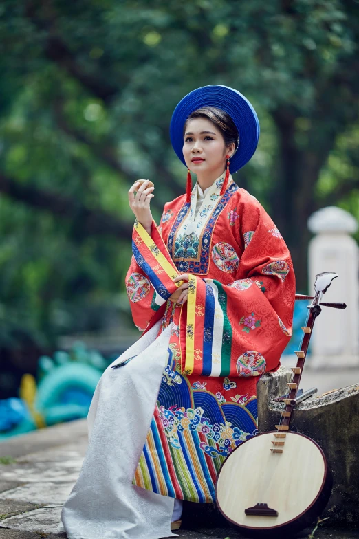 a young woman in a brightly colored costume holding a instrument