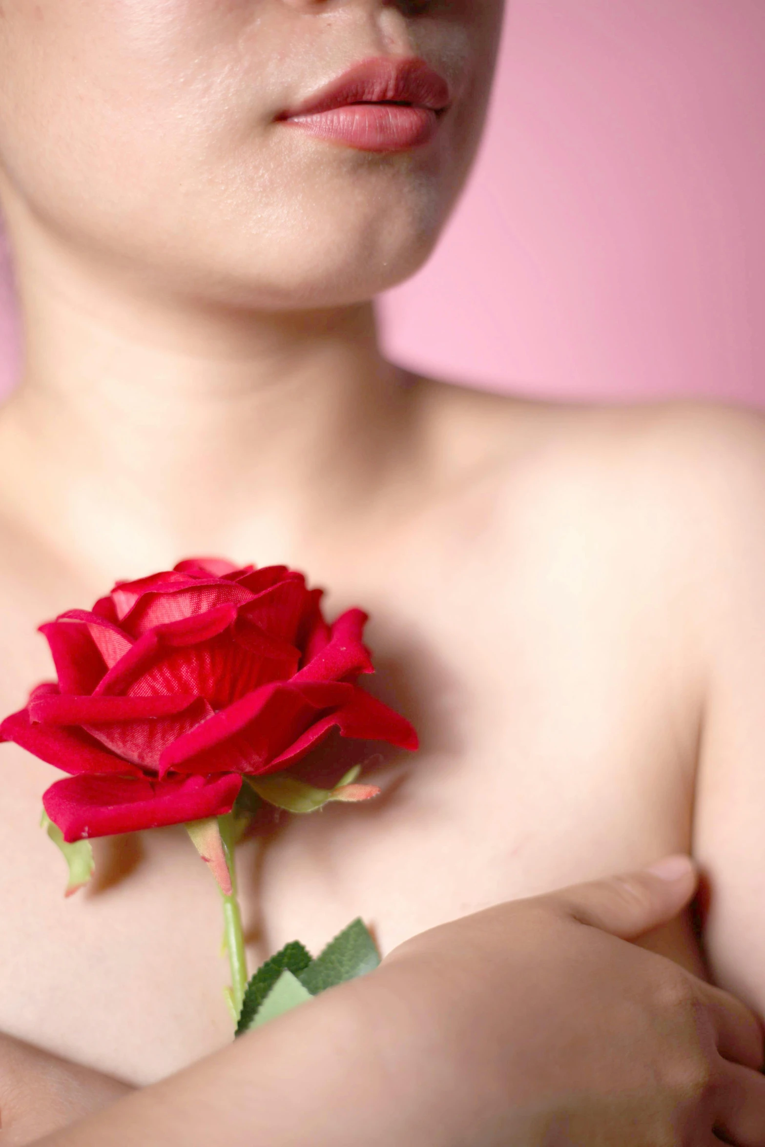 a woman holding a flower in her hands