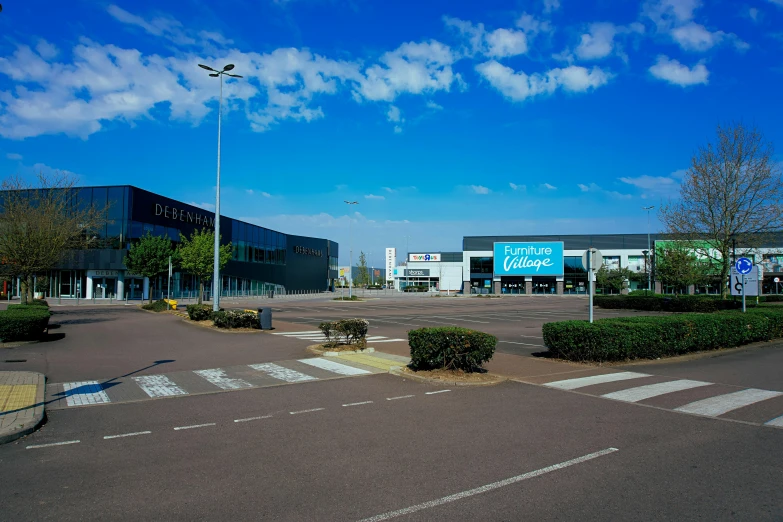 an empty street with many shops and businesses on it