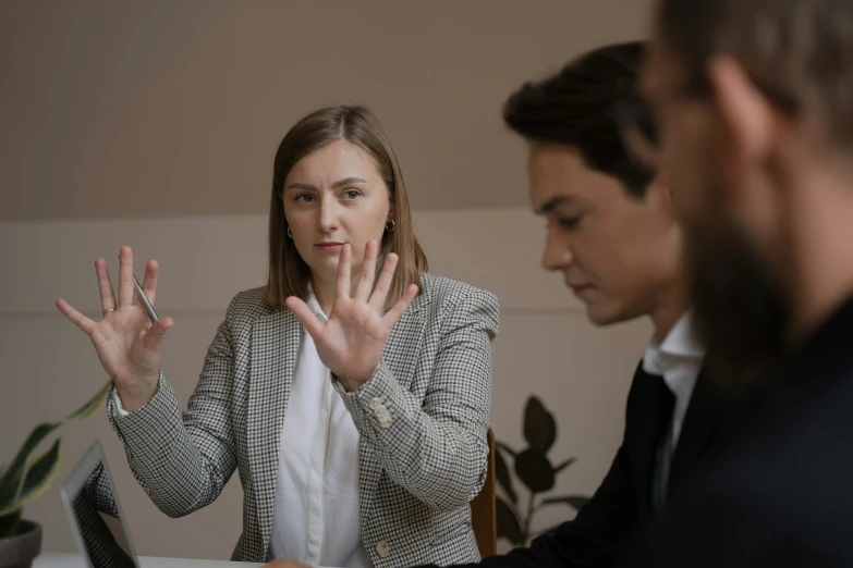 a woman is at a desk with two other people