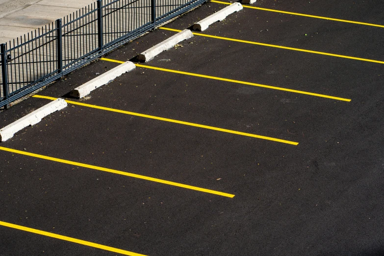 a parking lot with a fence in the middle