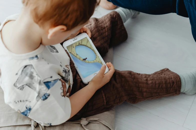 a little boy playing on his toy tablet