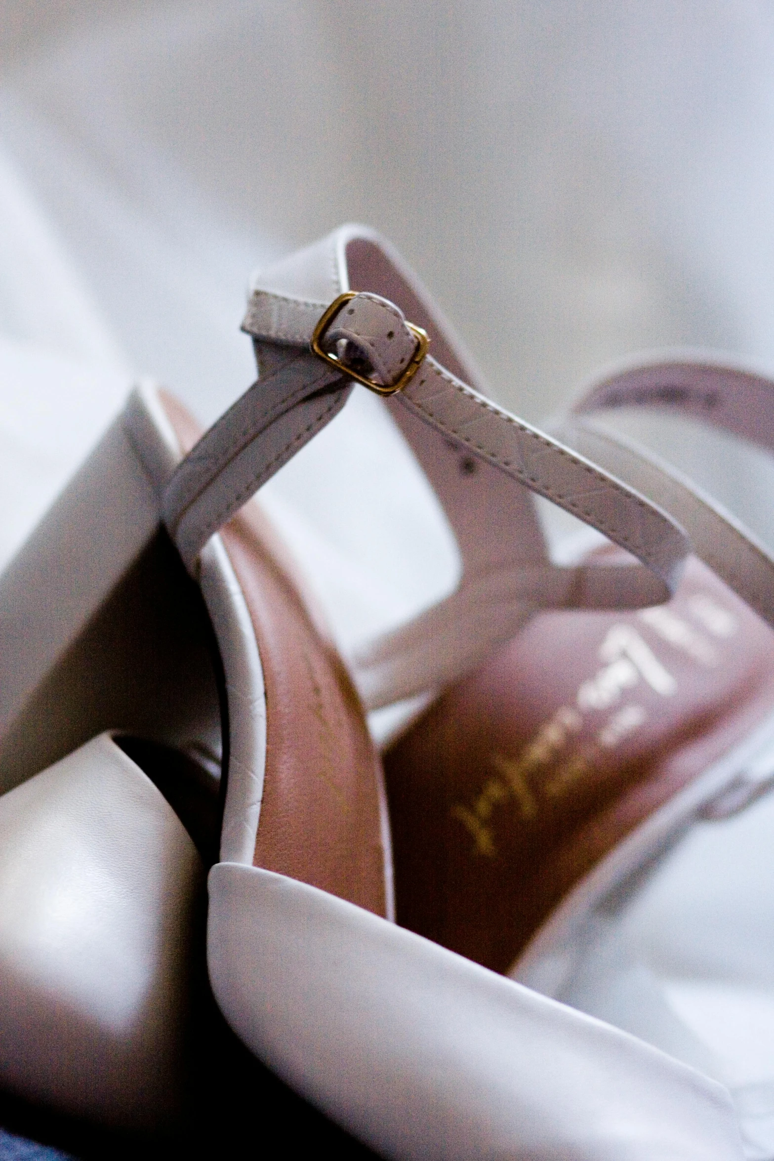 a pair of shoes sitting on top of a bed