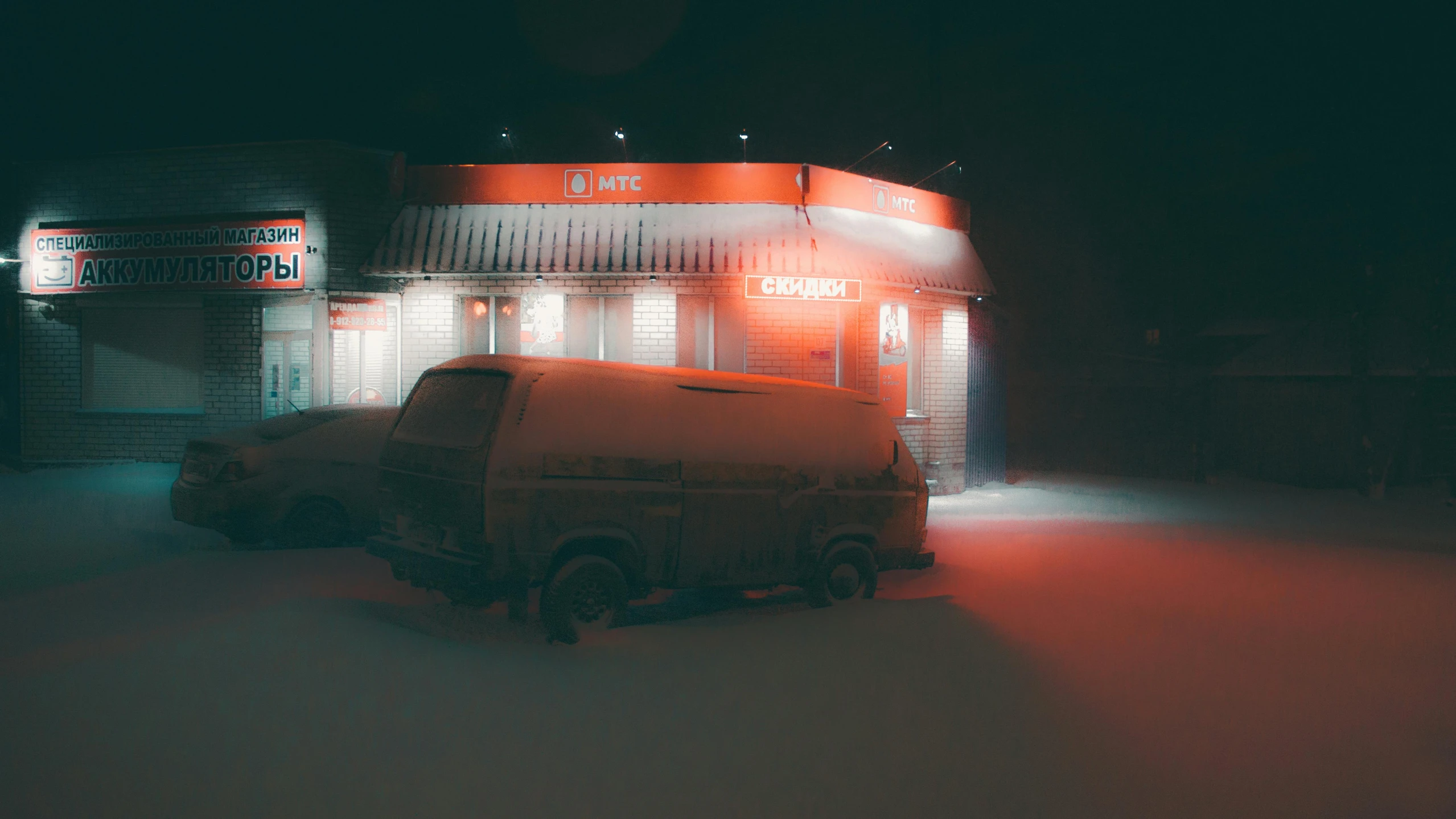 a van parked on the side of a street near a building