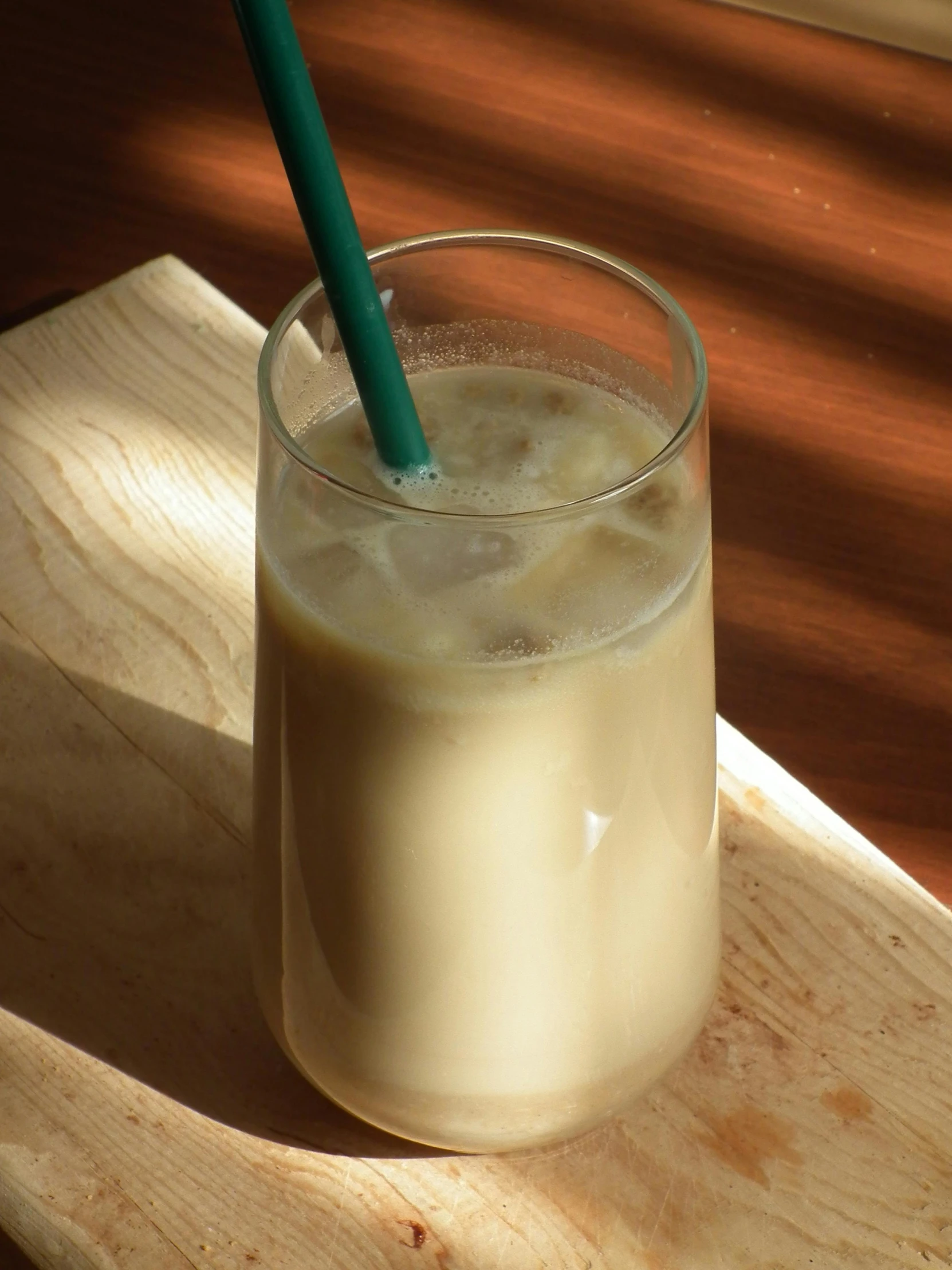 an unswothy glass full of milk and straw