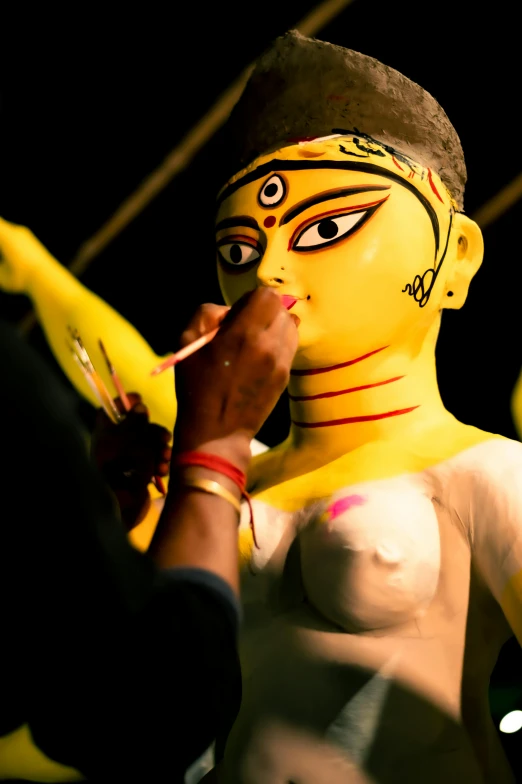 a woman dressed in yellow painted body paint