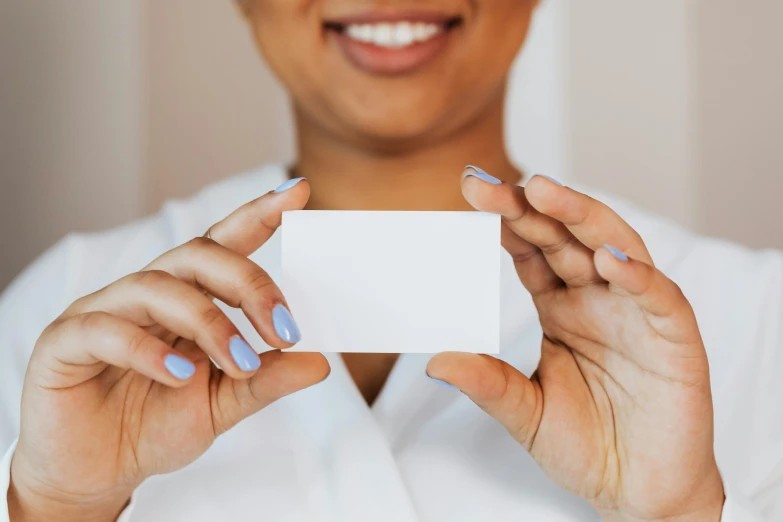 woman holding a business card in both hands