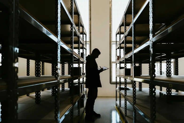 a man looking at his phone in the middle of the aisle