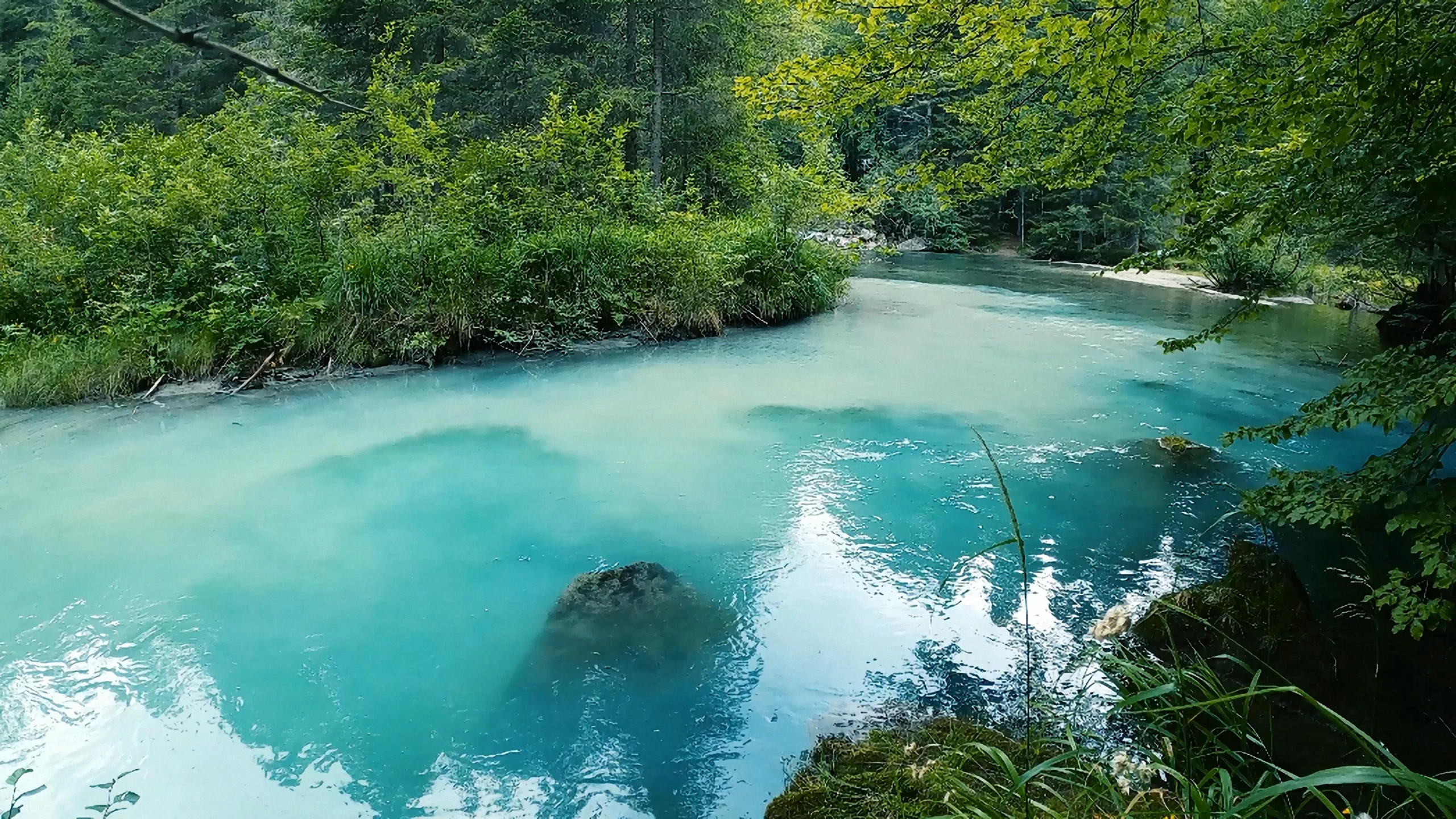 the blue water has many small rocks in it