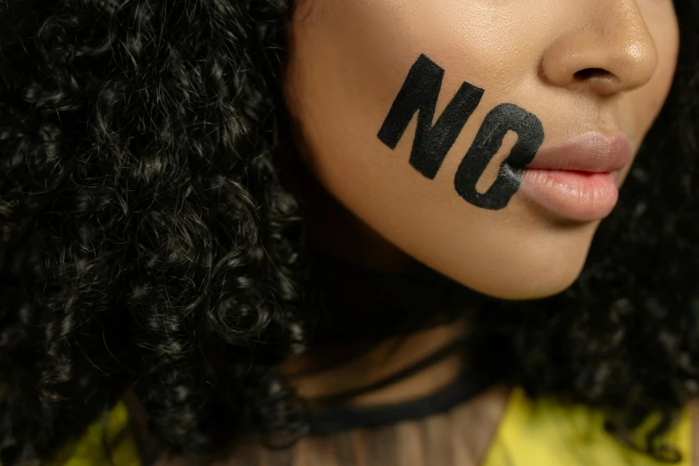 woman with words painted on her face