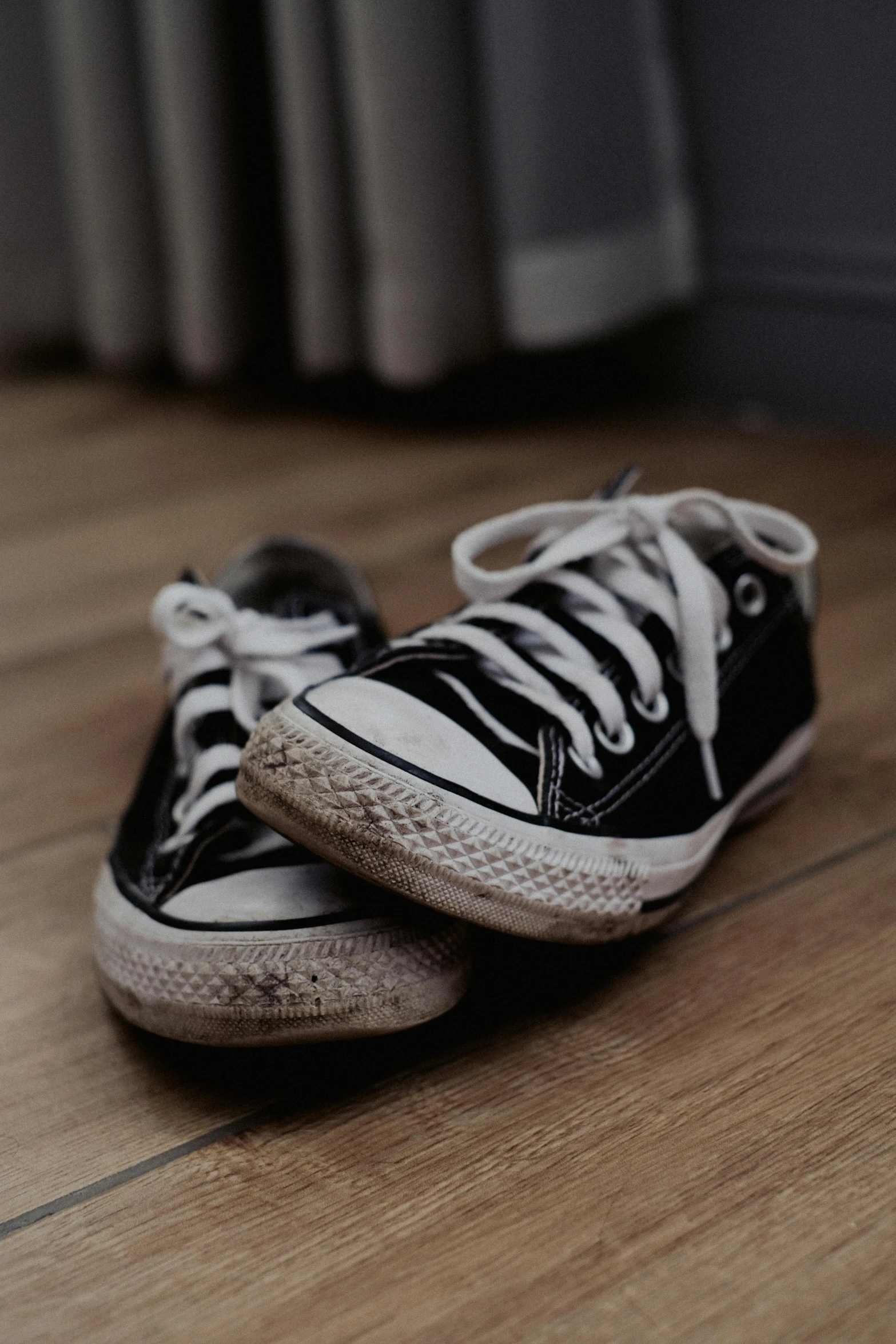 two sneakers sitting on the ground next to each other