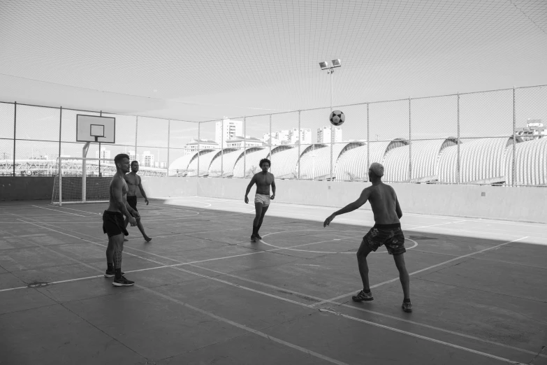 several young men playing a game of basketball