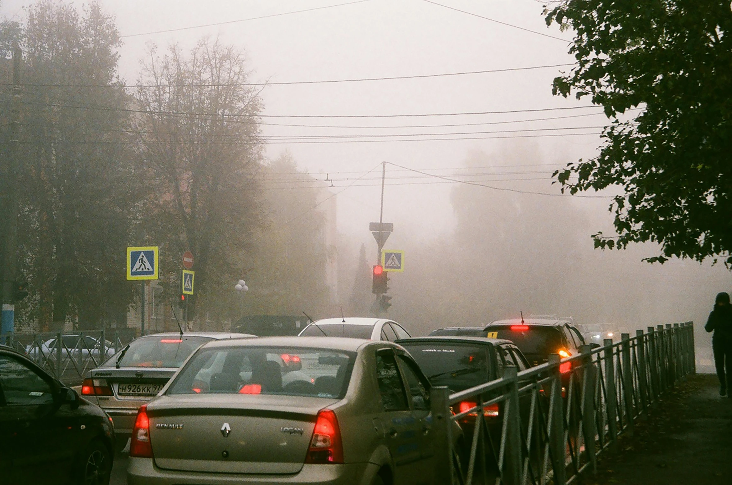 a street scene filled with traffic and a street light