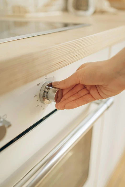 a person is picking soing out of the oven drawer