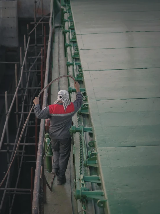 a person walking across a bridge with a rope