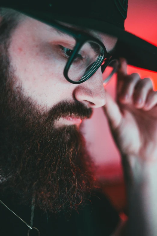 the man is talking on the phone while wearing glasses