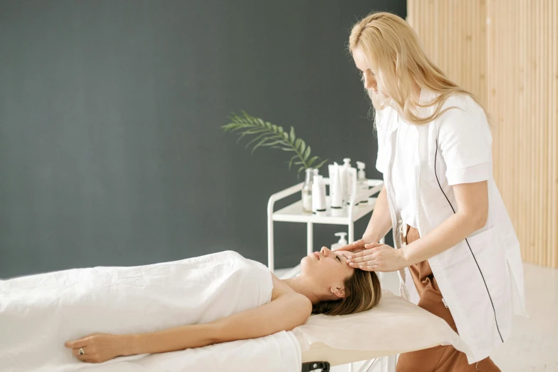 a woman is getting a back massage at the spa