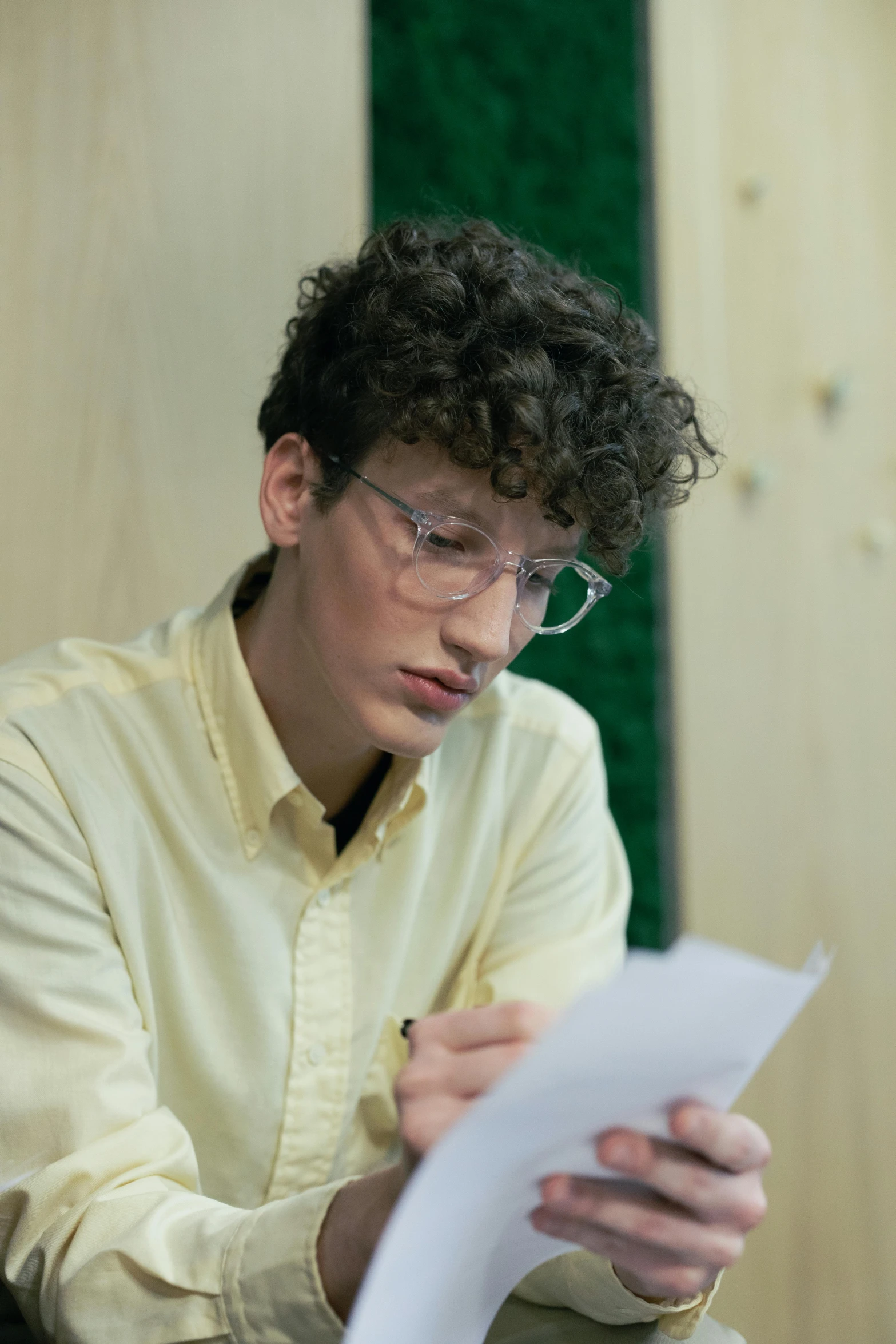 the man is sitting and reading a paper