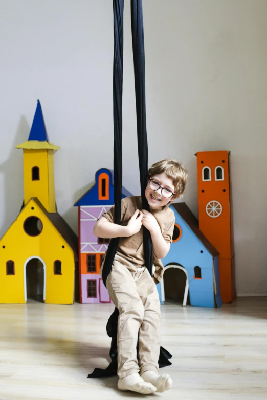 a small boy standing under some kind of umbrella