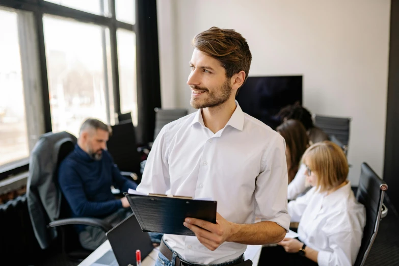 man in office with colleagues looking on