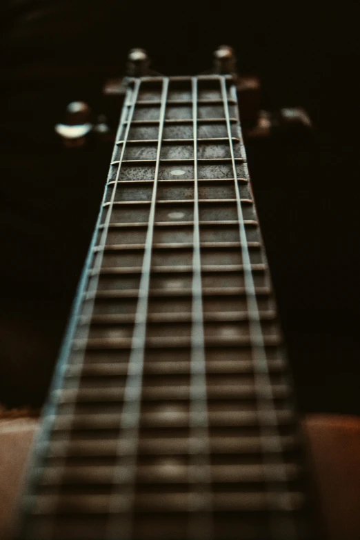 guitar fret close up showing the strings