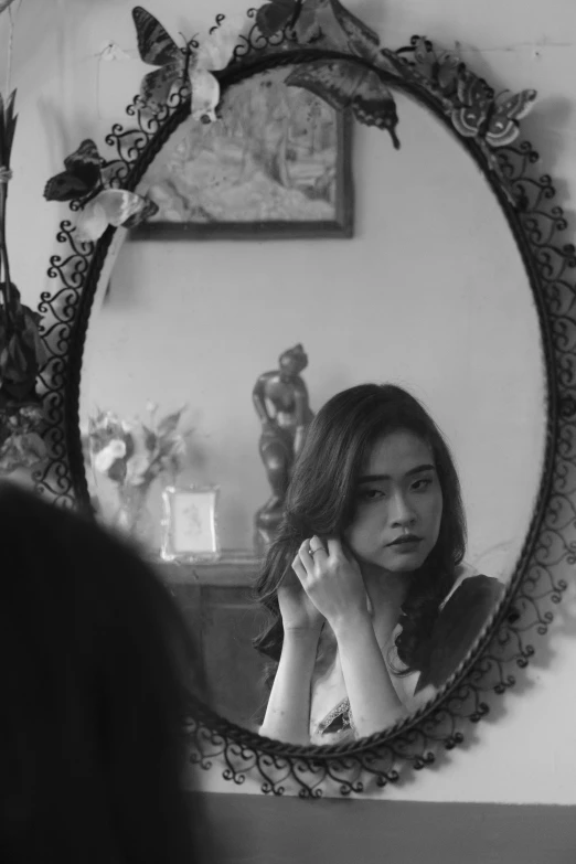 a young woman is reflected in the mirror