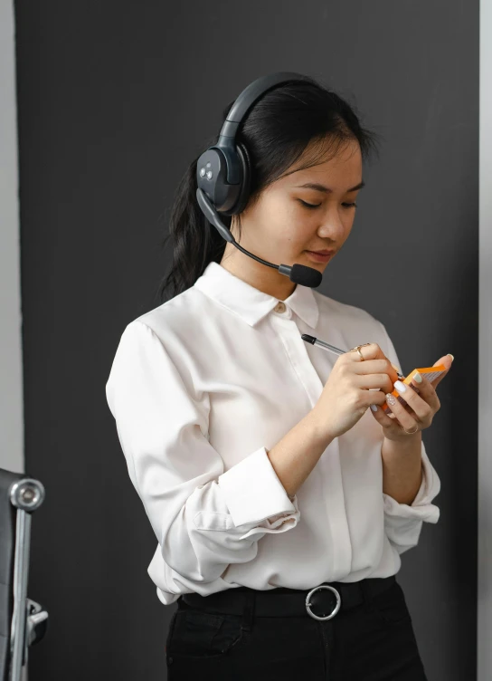 a woman in a headset holding a cellphone