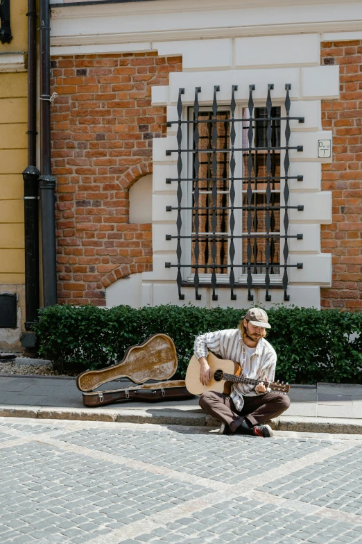 a man playing a guitar and a mandolin