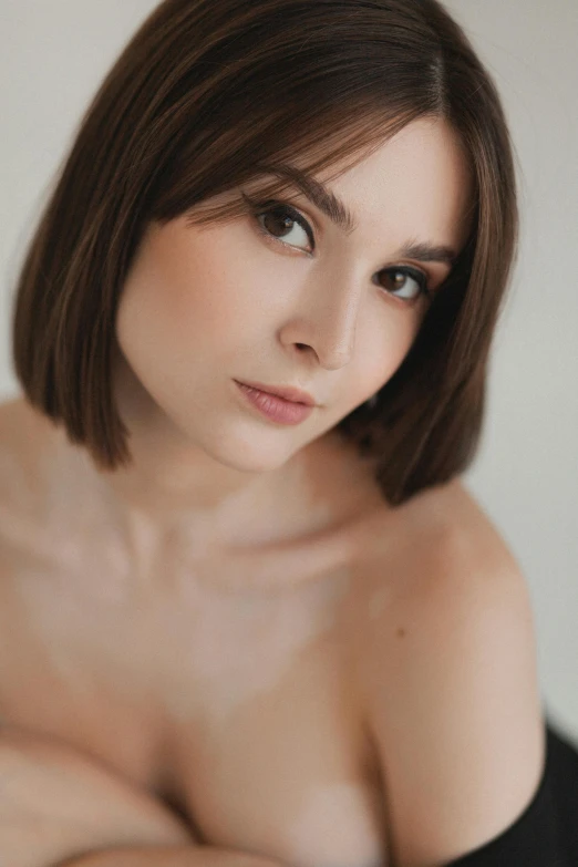 a woman with short hair and  posing for the camera