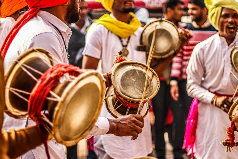 a group of drummers that are standing around playing instruments