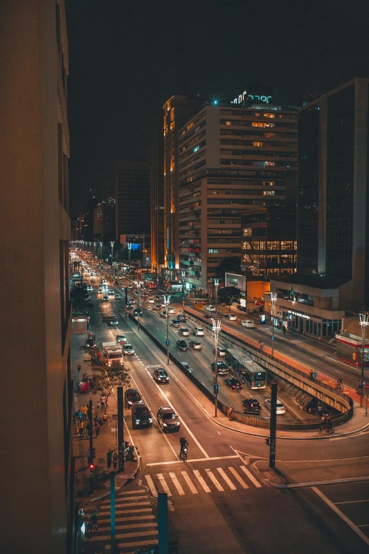 traffic in an empty street in the middle of city at night