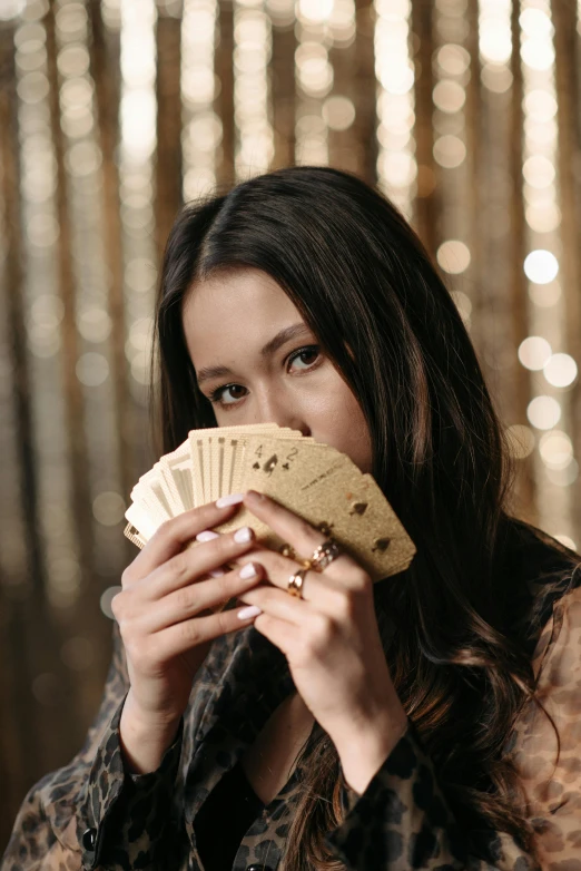 a woman holding a cookie and a stack of money