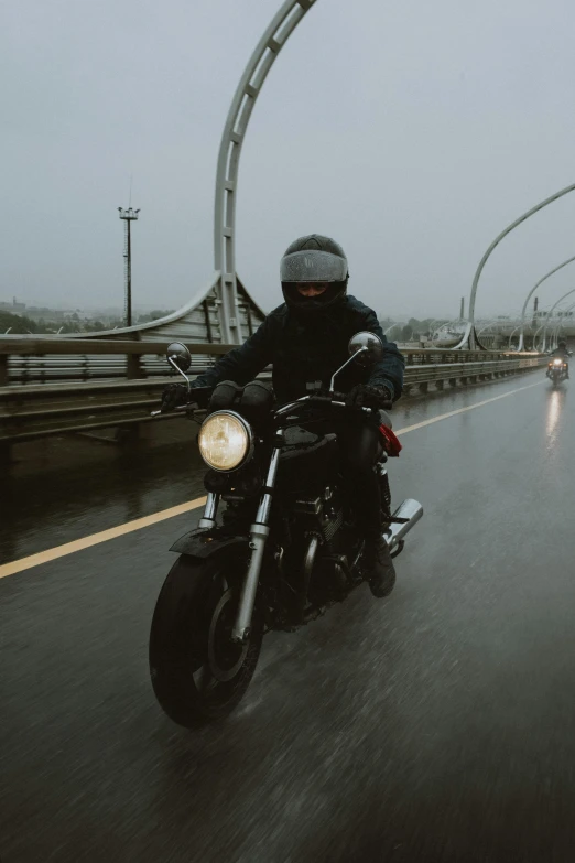 the man is riding his motorcycle along the road