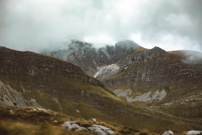 a couple of mountains with clouds in the sky