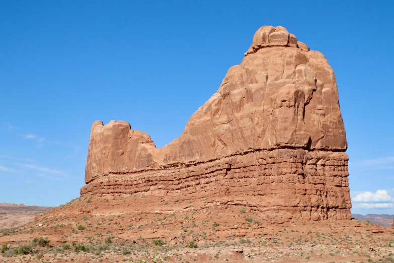 a rock formation in the desert under a blue sky