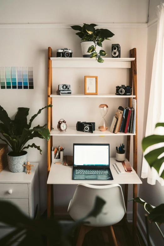 a laptop computer sitting on a white desk