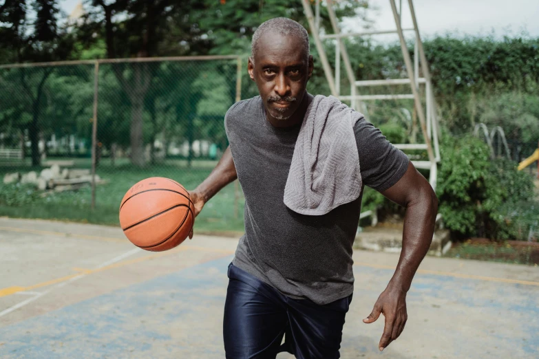 an adult man is dribbling a basketball