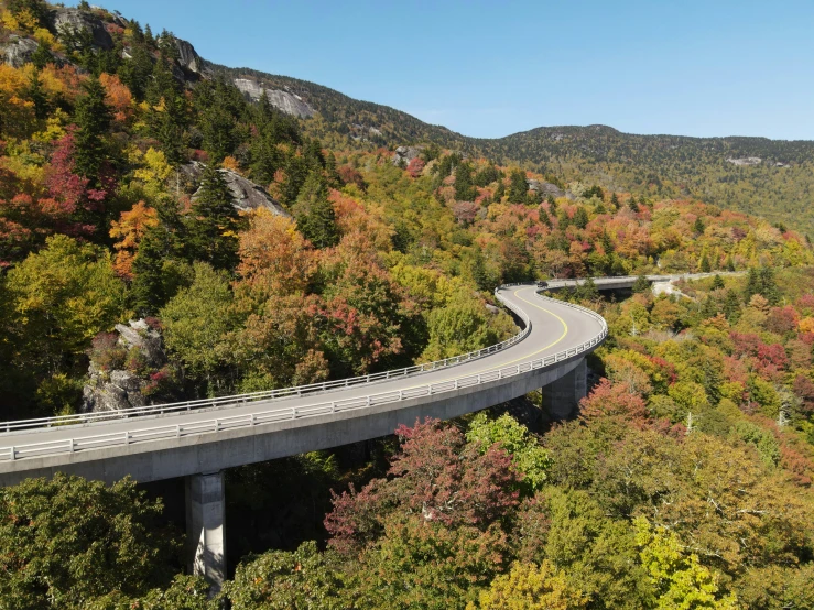 a curved highway is shown on a scenic mountain side