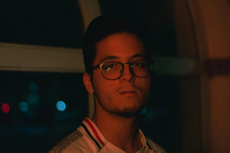 a man wearing glasses and a striped shirt