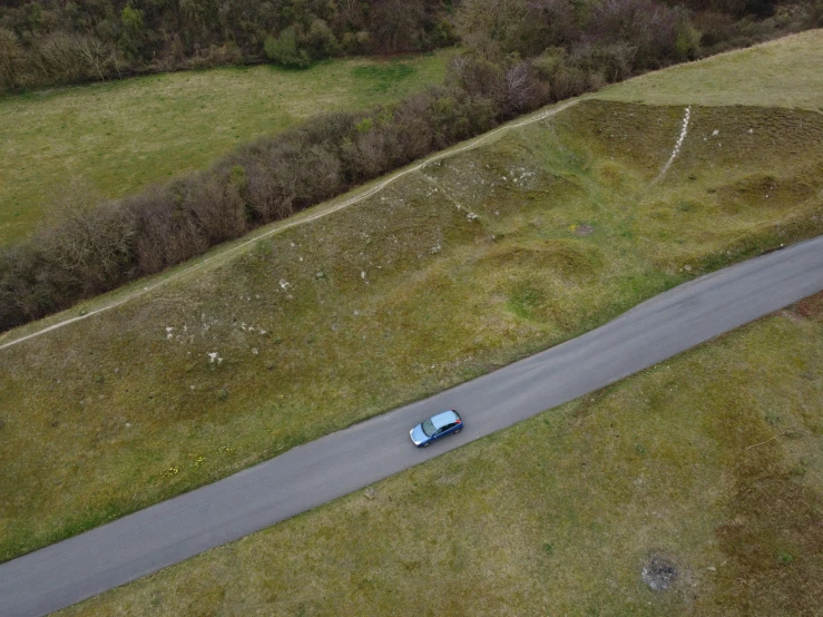 an aerial po of a car going down a hill